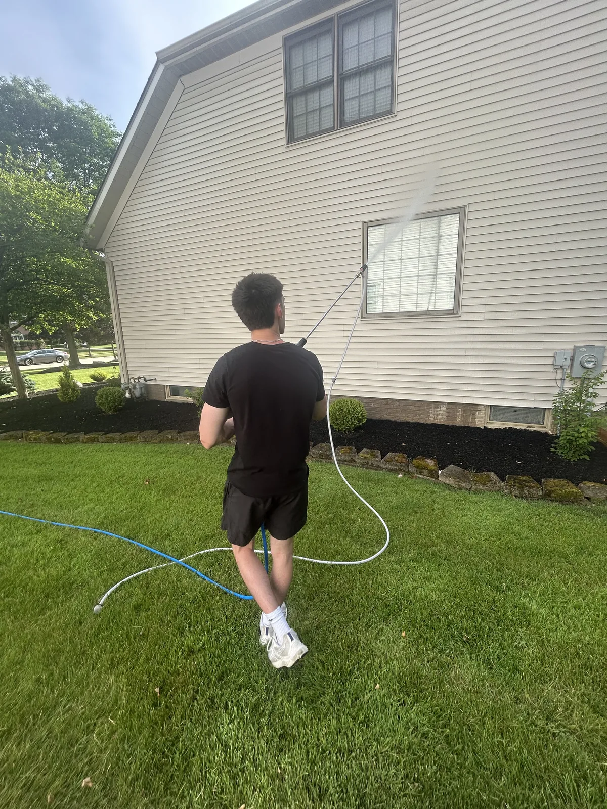 C2Clean owner pressure washing house siding in Aurora OH